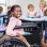 young girl on a wheel chair smiling at the camera