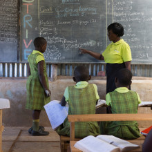 A teacher instructs pupils at a low-cost private school in Uganda, east Africa.
